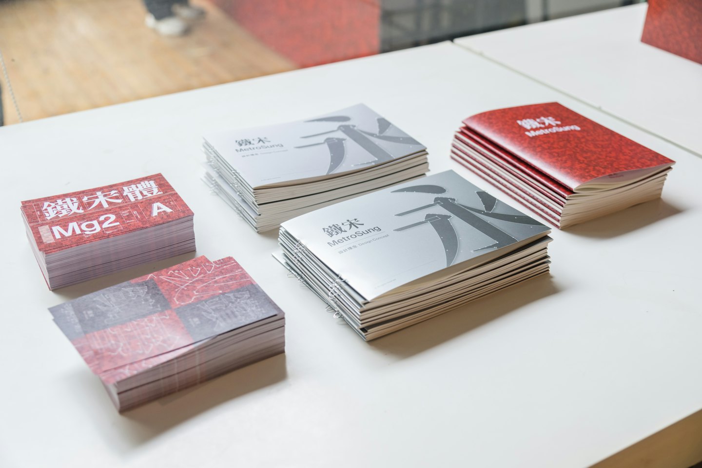 Pilas de folletos y tarjetas impresas sobre una mesa.